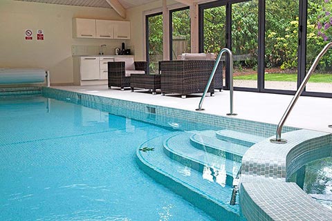 A pool extension viewed from the outside also showing the hosue it is attached to